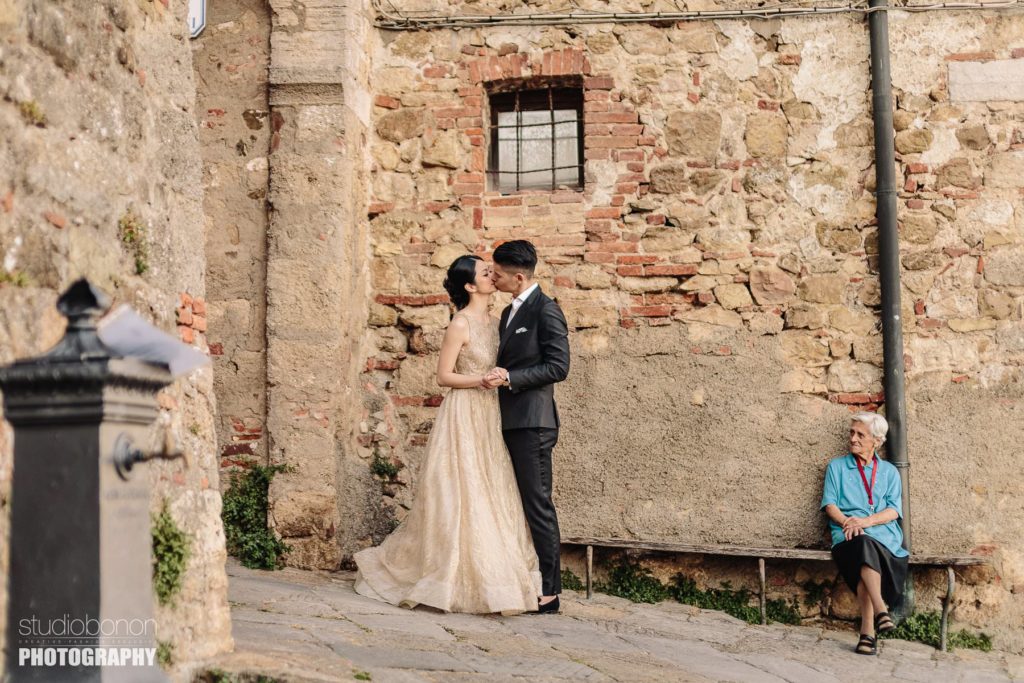 Bride and groom traditional Italian portrait in Tuscany countryside borgo near San Galgano